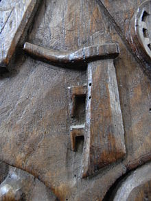 A ship's rudder carved in oak, 15th century, Bere Ferrers church, Devon. Heraldic badge of Cheyne and Willoughby families. RudderBereFerrersBenchEnd.jpg