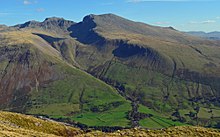 View of the Scafell massif from Yewbarrow, Wasdale, Cumbria. In the valley are older enclosures and higher up on the fell-side are the parliamentary enclosures following straight lines regardless of terrain. Scafell massif enclosures.jpg