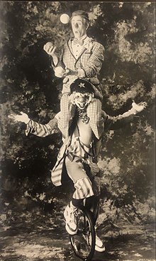 Alter and Reece, performing in 1991 Skeeter Reece carrying Albert Alter juggling while on unicycle.jpg