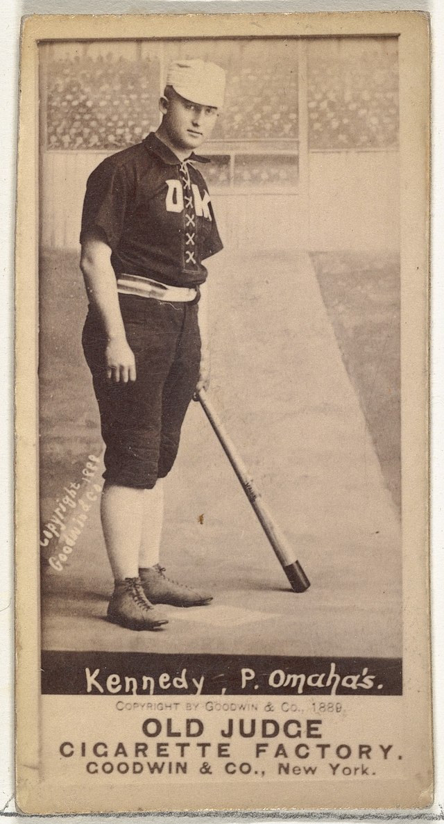Standing man in baseball uniform with bat