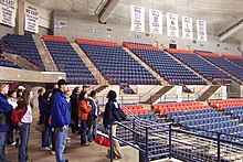 A student leading a 2005 campus tour at UConn shows off the school's women's basketball championship banners in the university's arena UConnTourBanners.JPG