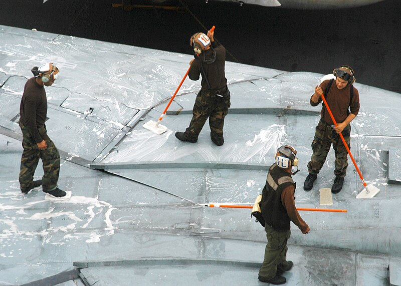 File:US Navy 031204-N-4669B-003 Flight deck personal from the "Checkmates" of Fighter Squadron Two One One (VF-211) scrub down an F-14 Tomcat on the flight deck of the Norfolk, Va. Based nuclear powered aircraft carrier.jpg