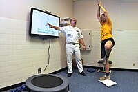 A video game is used during a physical therapy session at the Naval Health Clinic in Charleston. US Navy 090702-N-1783P-003 Hospital Corpsman 1st Class Guy Duke, left, and Electronics Technician 3rd Class Joshua Benedict demonstrate how the Physical therapy Department at Naval Health Clinic, Charleston use the Wii Fit's yoga.jpg