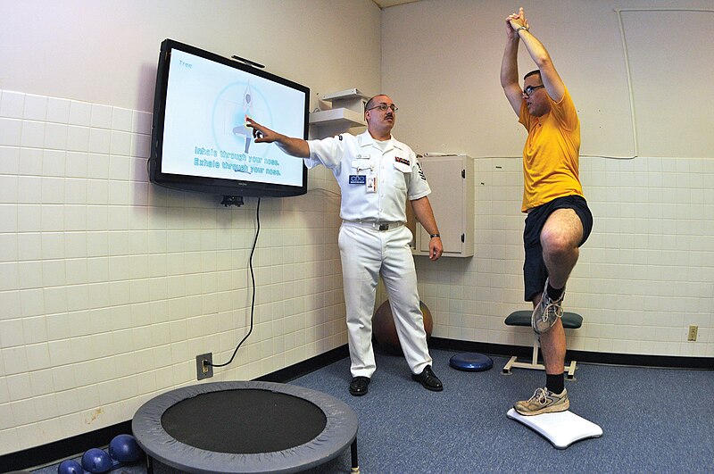 File:US Navy 090702-N-1783P-003 Hospital Corpsman 1st Class Guy Duke, left, and Electronics Technician 3rd Class Joshua Benedict demonstrate how the Physical therapy Department at Naval Health Clinic, Charleston use the Wii Fit's yoga.jpg