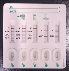 A urine screen with stripes that indicate the presence of different drugs