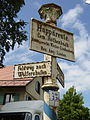 Cast iron column with place-name sign and signpost