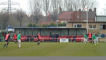 Whitworth's main stand "Woodley and Faulkner Stand" Wellingborough whitworth fc 60 seat main stand and paygate.jpg