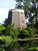 Westbroekmolen/Zuidbuurtse Molen. met riet gedekte molenromp op stenen onderbouw