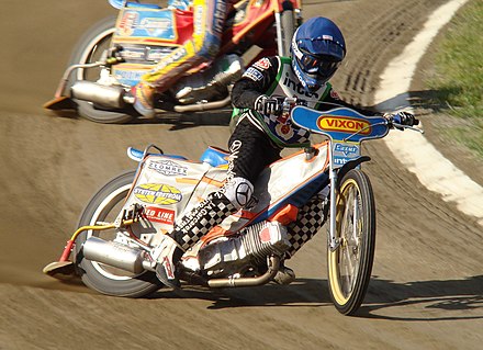 Close-up view of two speedway motorcycles in a race