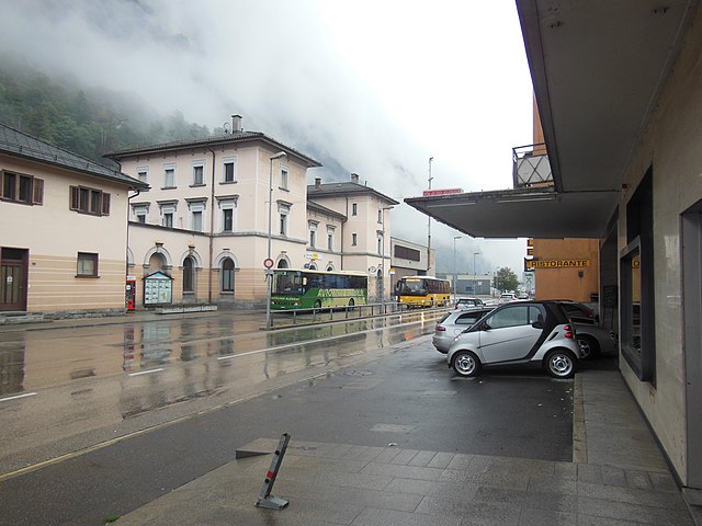 The frontage of Biasca railway station, with Autolinee Bleniesi and Autopostale buses