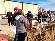Grand Rapids residents filling sand bags. 2013 Grand Rapids flood sandbags.jpg