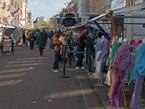 2023, photo Amsterdam city. People are walking and shopping at the Albert Cuyp market place in the sunlight of late March, with a group fashion dolls to the right - free download photo in Dutch street photography by Fons Heijnsbroek, Netherlands