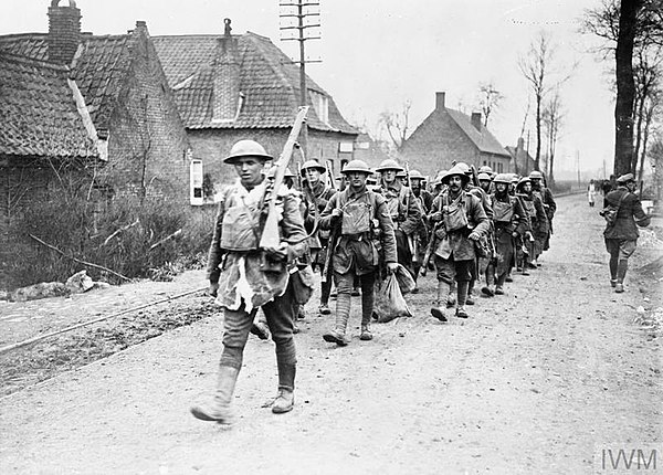 Men of 55th (WL) Division marching through Béthune after the defence of Givenchy, April 1918.