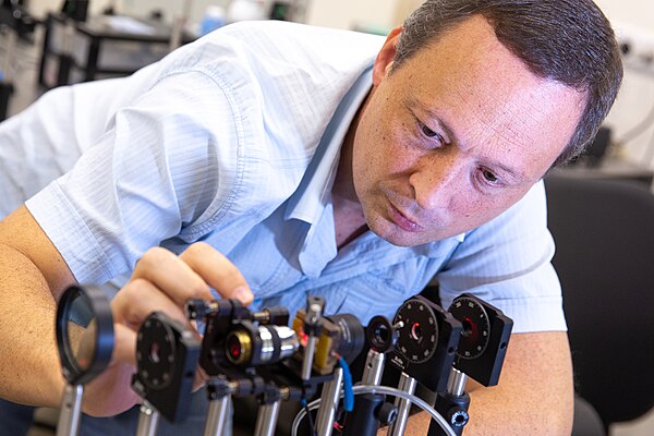 A researcher working on an optical system
