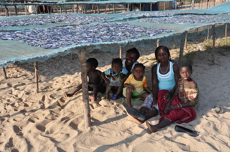 File:A family rests in the shade of nets used to dry fish (5887875035).jpg