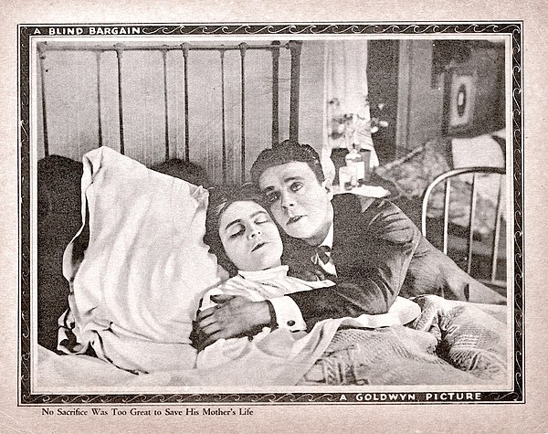 A lobby card, for the film, depicting Raymond McKee, as the main character, with his mother.