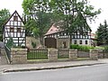 Residential stable house, side building, enclosure and gate system of a former three-sided courtyard