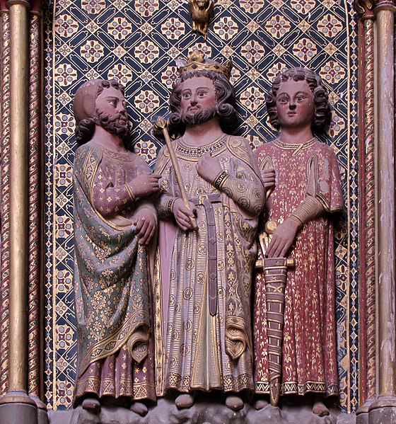 Charles in a 14th-century sandstone relief, flanked by a squire and a knight.