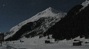 Nameless pre-summit point 2549 of the Börthorn from the north, with a full moon over the Dischma valley.