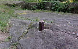 This one of John Randel's survey bolts marked the location of what would have been Sixth Avenue and 65th Street; the location later became part of Central Park[95]