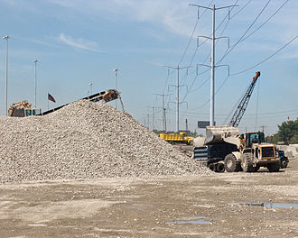 Recycled crushed concrete, to be reused as granular fill, is loaded into a semi-dump truck Crushed Concrete Granular Fill.jpg
