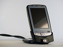 A charging cradle with contacts that connect to the device being charged. HP IPAQ hx2110 Charge cradle.jpg