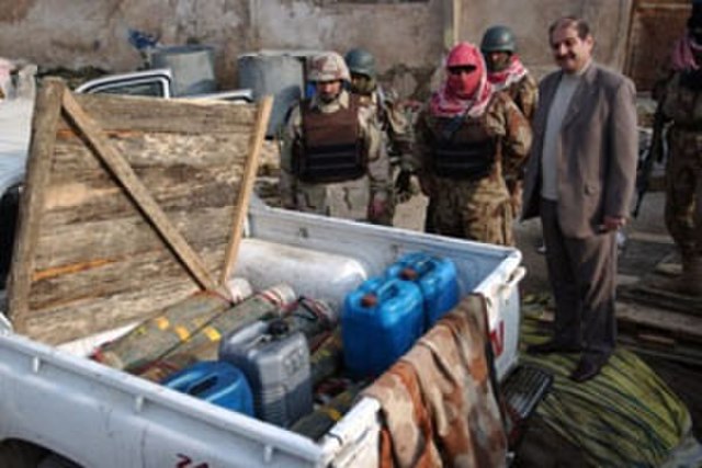 Artillery shells and gasoline cans discovered in the back of a pick-up truck in Iraq