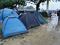 The campsite at the Isle of Wight Festival 2011, seen on Sunday during heavy rain. The rain had caused much of the site to turn to mud, damaging tents and causing problems for campers.