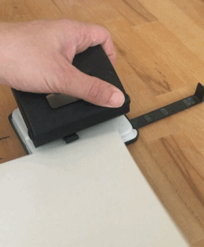 A hole punch in use