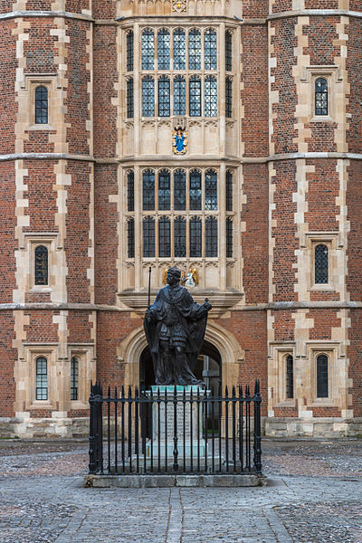 A statue of Henry VI, the college's founder, in the school yard and Lupton's Tower (background)