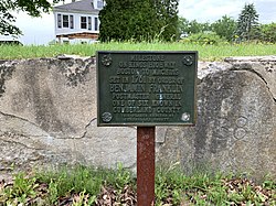 A milestone on the Boston-to-Machias "King's Highway" route. The milestone, now incorporated into a wall, is engraved with "B 138," to denote its distance of 138 miles from Boston. It is located on Pleasant Street Mile marker Yarmouth.jpg