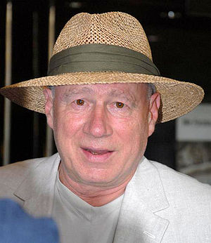 Innes smiling in a large-brimmed hat