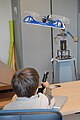 English: A child discovering a device with propellers used for studies about control theory (open doors for popular science at LAAS-CNRS in Toulouse, France). Français : Un enfant découvrant le fonctionnement d'un modèle réduit comprenant des pales d'hélicoptères utilisé pour des recherches en automatique (portes ouvertes du LAAS-CNRS, Toulouse, France).