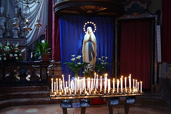 Prayer candles in front of a Madonna in the Collegiata di San Vittore in Canobio