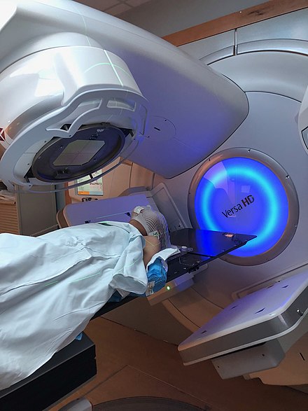 Patient receiving radiation therapy to the region of the head and neck. Full facial mould is in place to protect areas where they do not want exposure.