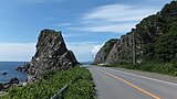 Roadway alongside a rocky beach