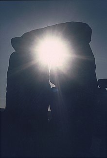 The sunlight shining through a trilithon at Stonehenge Stonedhenge.jpg