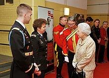 Members of the concert band with Queen Elizabeth II, December 2011. USAREUR Band CDR and Her Majesty The Queen.jpg