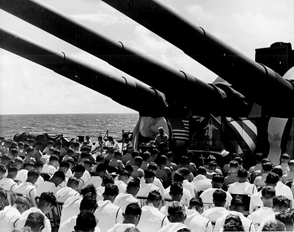 On 1 July 1944, Chaplain Lindner reads the benediction held in honor of USS South Dakota shipmates killed in the air action off Guam