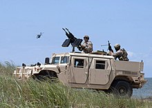 U.S. Navy SEALs and GMV-N US Navy 110716-N-VY959-122 U.S. Navy SEALs ride in a Navy Special Warfare humvee to provide security for a simulated prisoner.jpg