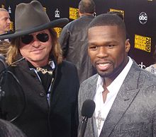 Kilmer standing next to 50 Cent who is being interviewed