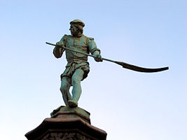 Craft guild statue of the Bleacher Petit Sablon Square in Brussels, Belgium.