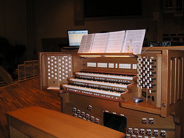 Rodgers Trillium organ custom three-manual console on a church. right top: a sound module for extra pipe and orchestral sounds. left top: a laptop PC 