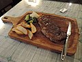 A angus beef steak with potato slices and vegetables.jpg
