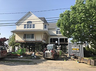 A house raised and held on box cribs during foundation work A house raised and held on box cribs during foundation work provided by Patterson Structural Shoring.jpg