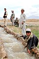 Afghan boys line an irrigation canal in Logar Province.jpg