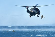 2 RAR soldiers helocasting from a MRH-90 helicopter during Exercise Sea Series 2018 Australian soldiers jumping out of a MRH-90 in 2018.jpg