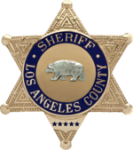 The Los Angeles County Sheriff's Office badge is typical of the six-pointed star design used by many U.S. sheriffs. The panel at the bottom of the badge is where a deputy's badge number would be engraved. Badge of the Sheriff of Los Angeles County.png