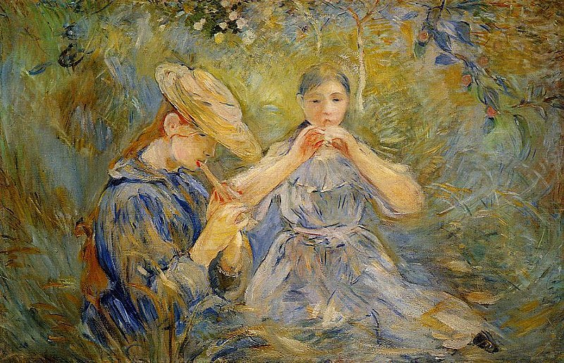 Two girls playing flutes sitting in a field of flowers
