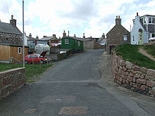 Former fishing cottages and outbuildings with converted railway wagon